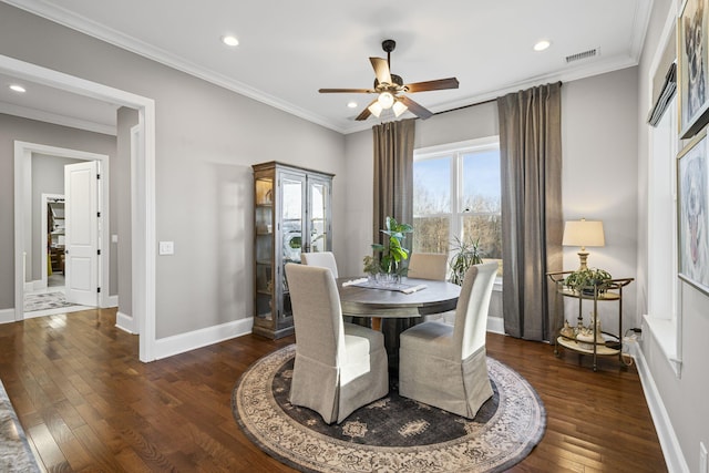 dining space with dark wood-type flooring, ceiling fan, and crown molding