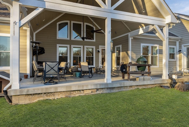 back of house with a lawn and ceiling fan