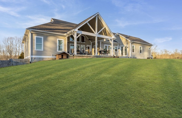 rear view of house featuring a yard, ceiling fan, and a patio area