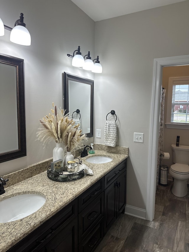 bathroom with hardwood / wood-style flooring, vanity, and toilet