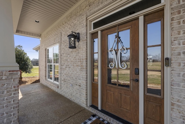 property entrance featuring brick siding