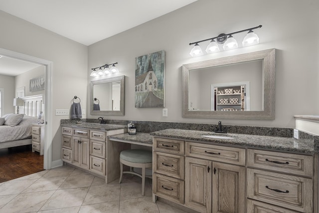 ensuite bathroom with ensuite bathroom, vanity, and tile patterned floors