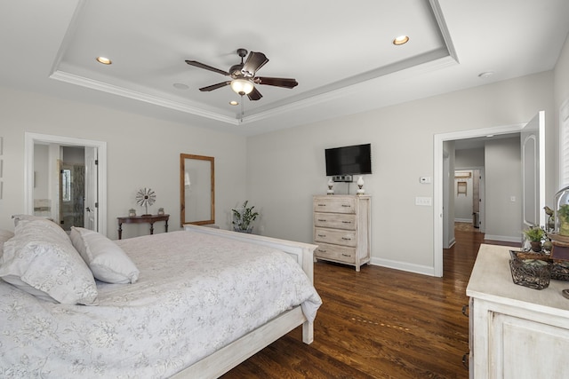 bedroom featuring dark wood-style floors, a tray ceiling, baseboards, and recessed lighting