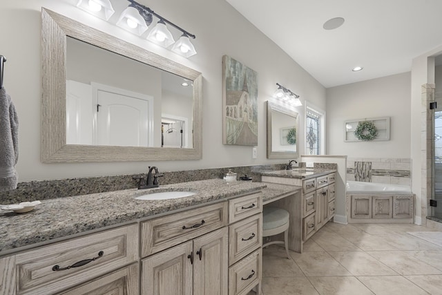 bathroom featuring an enclosed shower, tile patterned flooring, a garden tub, and vanity