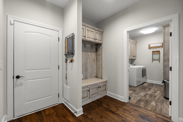 mudroom with washing machine and dryer, visible vents, dark wood finished floors, and baseboards