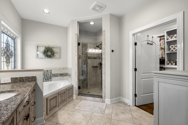 bathroom with a stall shower, visible vents, vanity, a bath, and recessed lighting