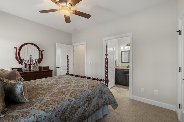 bedroom with baseboards, ceiling fan, ensuite bathroom, and light colored carpet