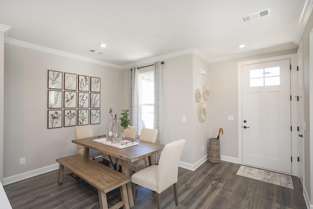 dining space with dark hardwood / wood-style flooring and crown molding