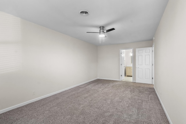 spare room featuring light carpet and ceiling fan