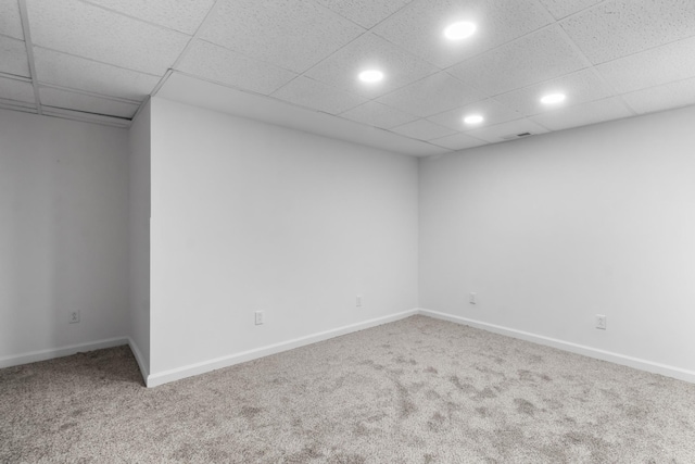 spare room with carpet flooring and a paneled ceiling