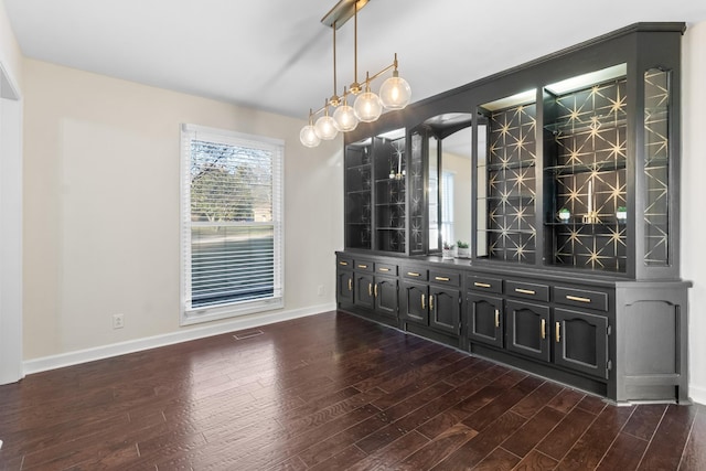 bar with dark wood-type flooring