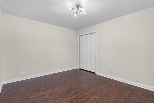 unfurnished bedroom featuring dark wood-type flooring and a closet