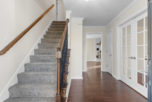 stairs featuring hardwood / wood-style flooring, ornamental molding, and french doors