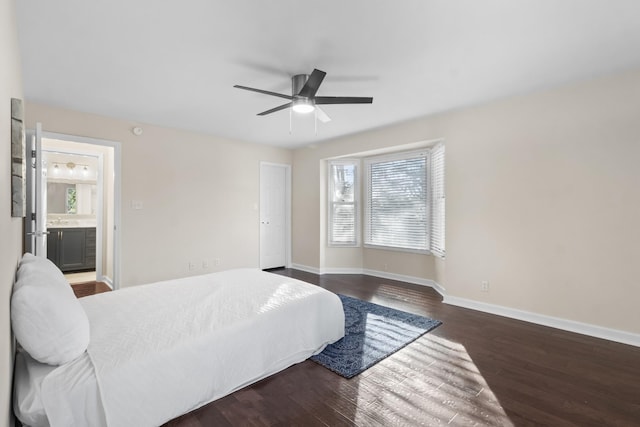 bedroom with ensuite bathroom, dark hardwood / wood-style floors, and ceiling fan