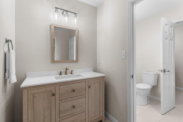 bathroom with tile patterned floors, vanity, and toilet