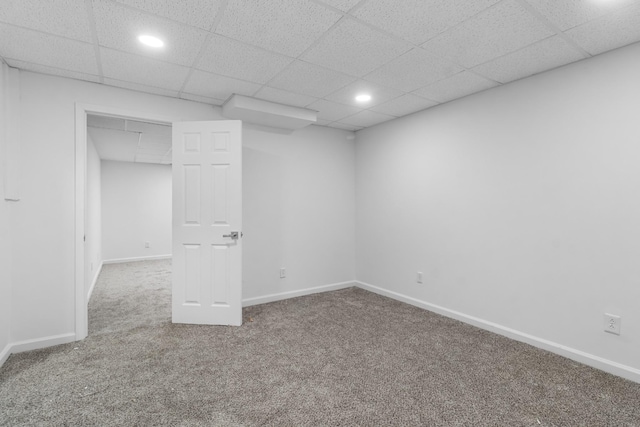 unfurnished bedroom featuring carpet floors and a paneled ceiling