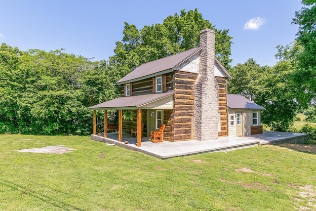 back of house with a yard and an outdoor structure