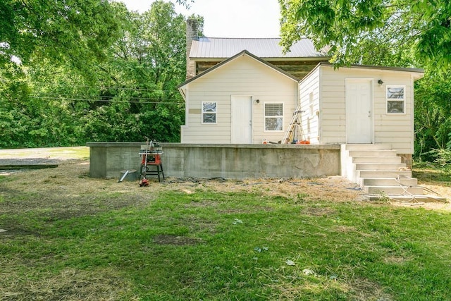 back of house featuring a lawn