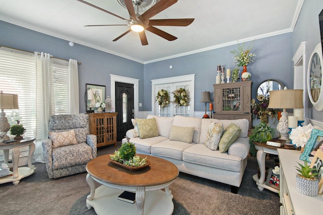 living room featuring crown molding, ceiling fan, and carpet flooring