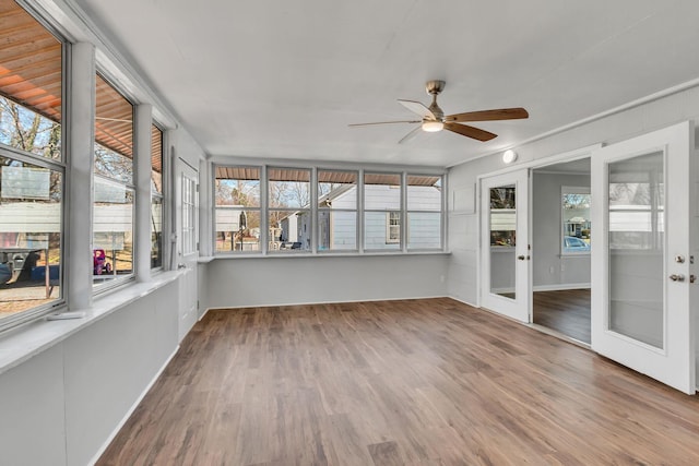 unfurnished sunroom with ceiling fan