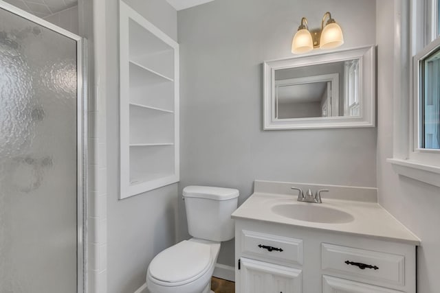 bathroom with vanity, an enclosed shower, and toilet