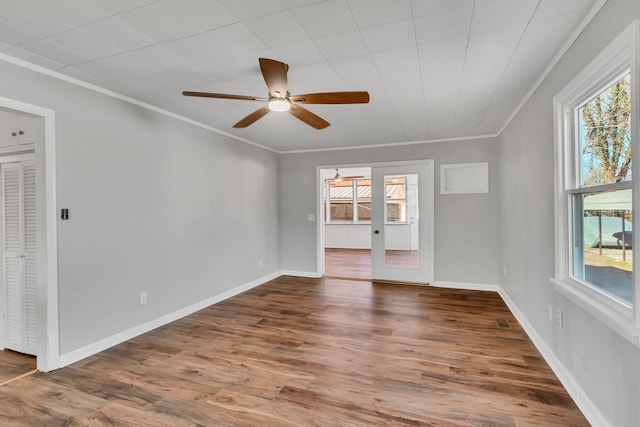 empty room with crown molding, ceiling fan, and hardwood / wood-style flooring