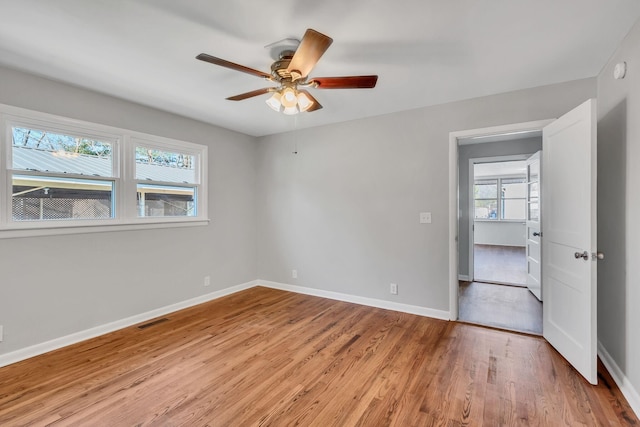 spare room featuring ceiling fan and light hardwood / wood-style flooring