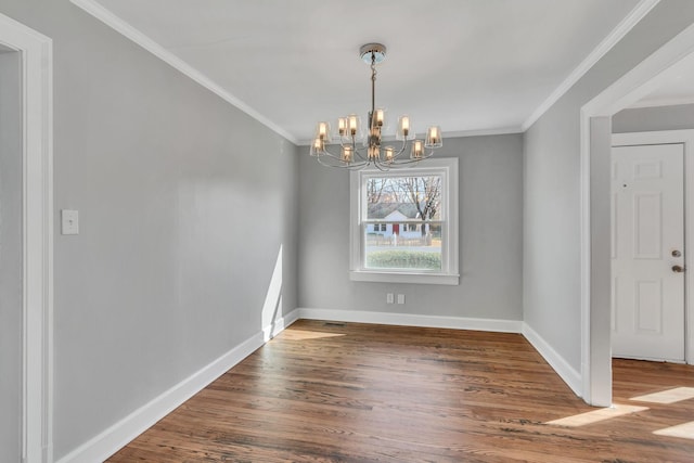 unfurnished dining area featuring ornamental molding, wood-type flooring, and a notable chandelier