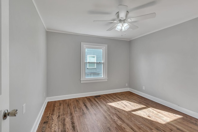 spare room featuring crown molding, wood-type flooring, and ceiling fan