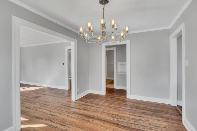 unfurnished dining area with an inviting chandelier, crown molding, and dark wood-type flooring