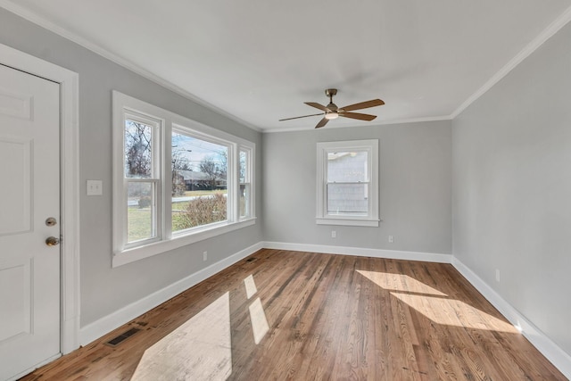 unfurnished room featuring wood-type flooring, ceiling fan, and crown molding