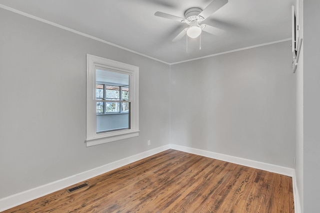 spare room featuring hardwood / wood-style flooring, ornamental molding, and ceiling fan