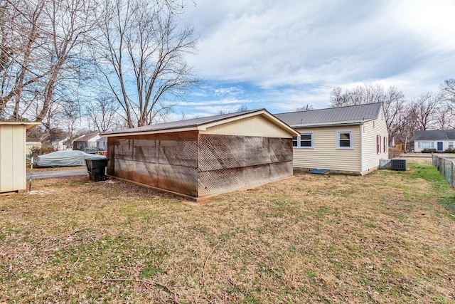 back of house with a yard and central AC unit