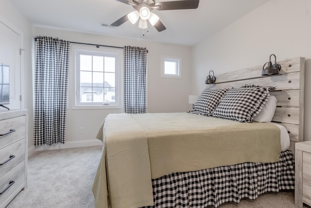 bedroom with ceiling fan and light carpet