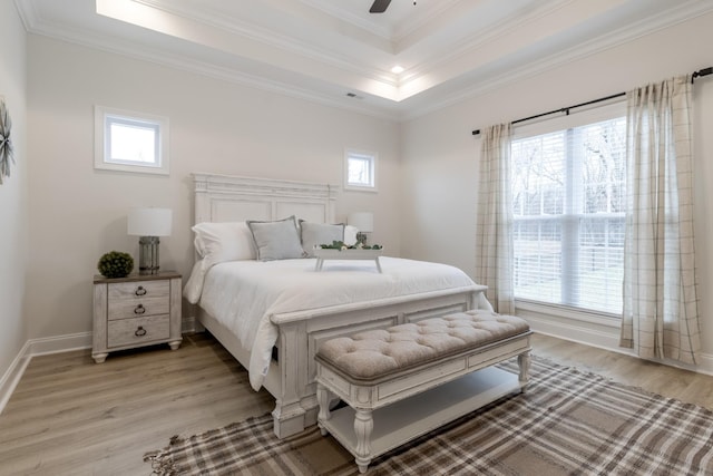 bedroom featuring multiple windows, ornamental molding, and light hardwood / wood-style floors