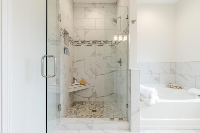 bathroom with shower with separate bathtub