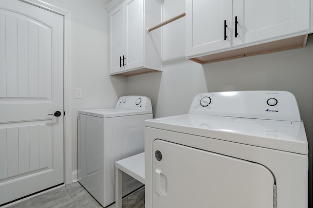 washroom with cabinets and independent washer and dryer