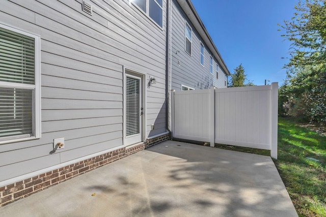 view of side of home featuring a patio area