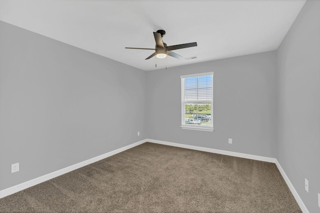 unfurnished room featuring ceiling fan and carpet