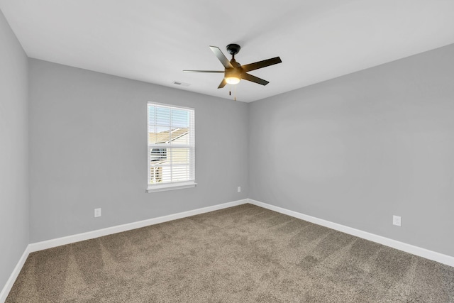 carpeted spare room featuring ceiling fan