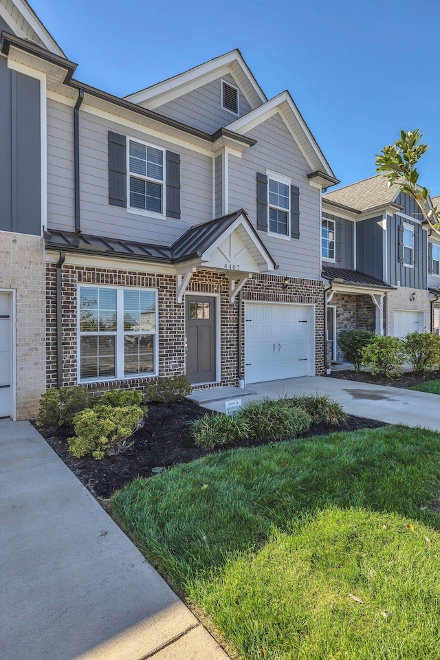 townhome / multi-family property featuring a garage and a front yard