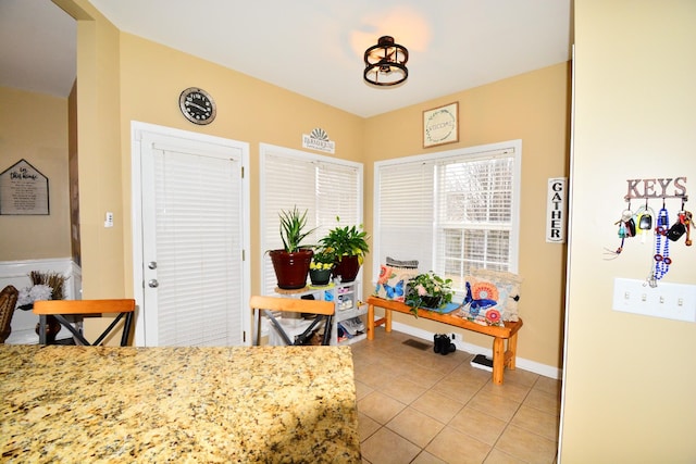 dining space featuring light tile patterned flooring