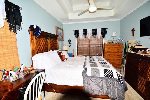 bedroom featuring a tray ceiling, ornamental molding, and ceiling fan