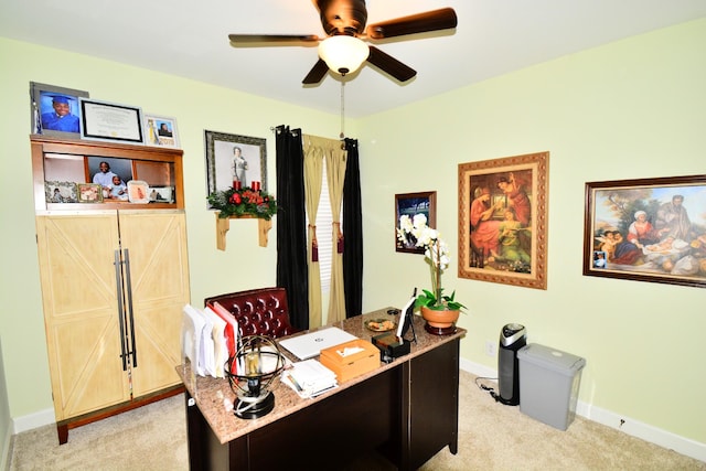 carpeted office featuring ceiling fan