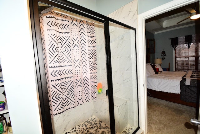 bathroom featuring a shower with door and crown molding