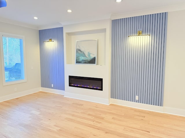 unfurnished living room with light hardwood / wood-style flooring and ornamental molding