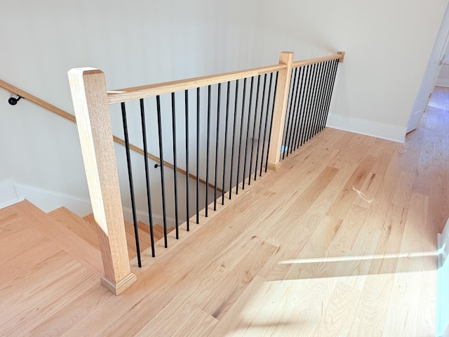 stairway with hardwood / wood-style flooring