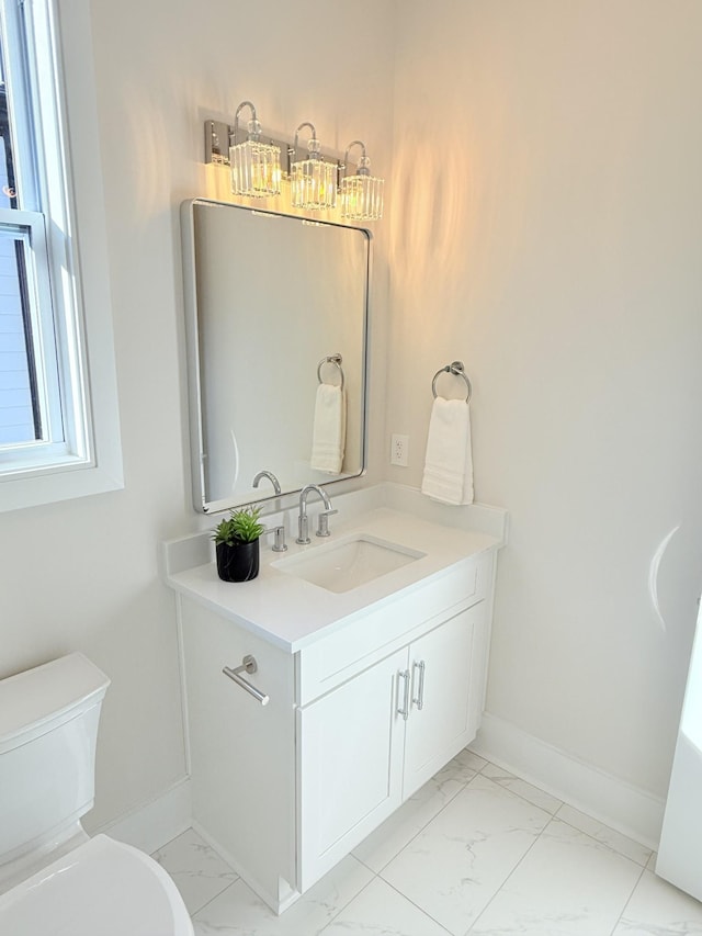 bathroom featuring vanity and toilet