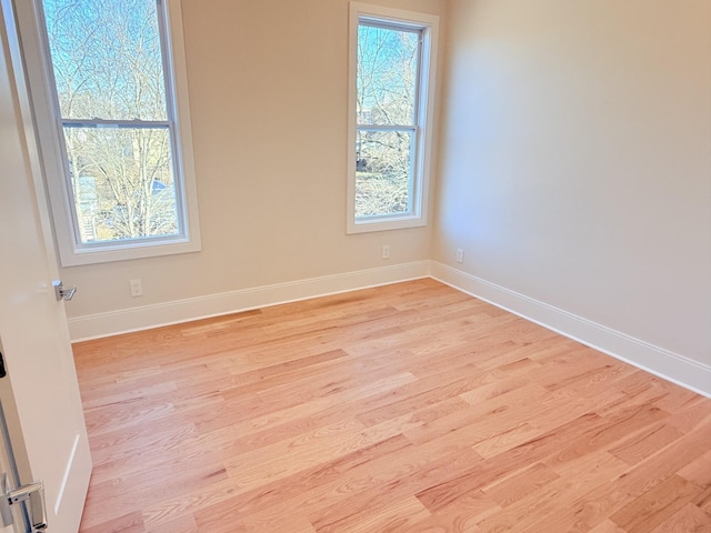 spare room featuring light wood-type flooring