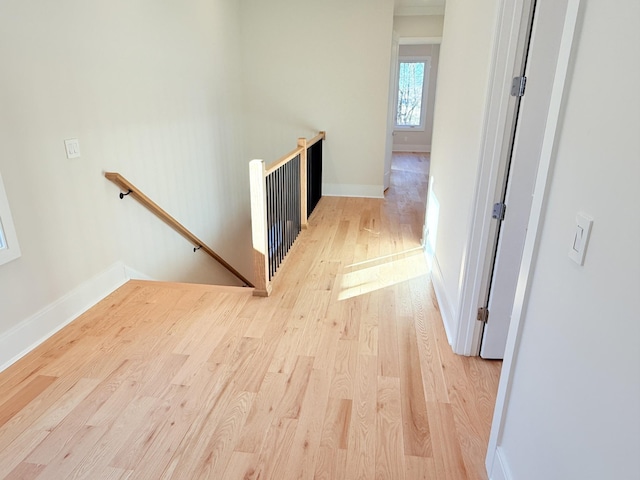 corridor with light hardwood / wood-style flooring